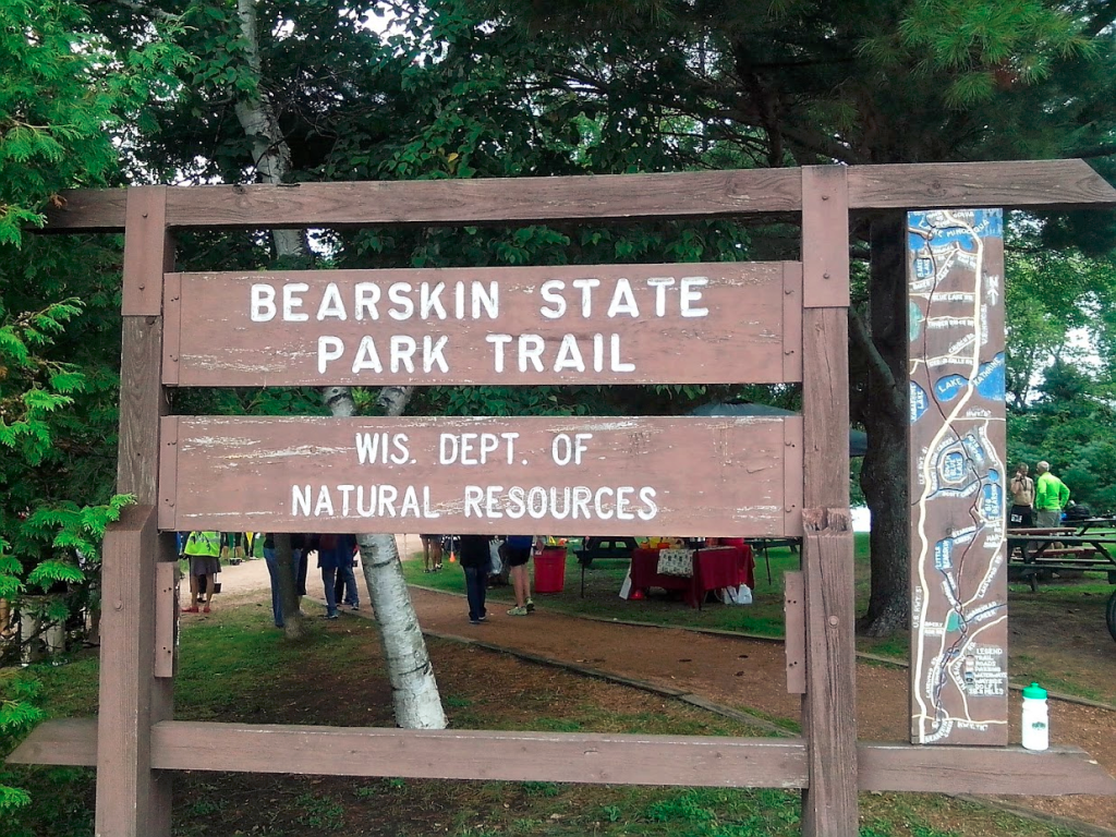Sign and map for Bearskin State Park Trail at finish line (with free water bottle)